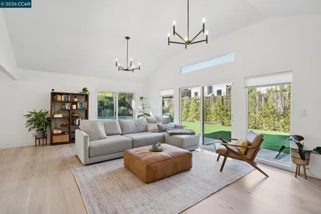 a living room with furniture and floor to ceiling windows