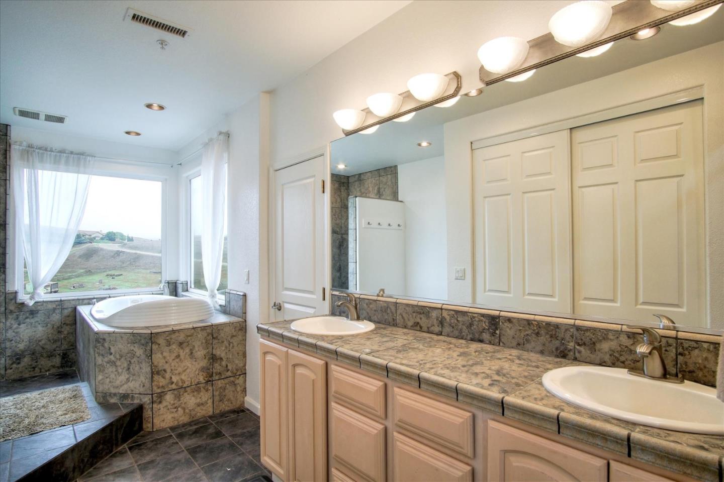 35635 Eagle Ridge Soledad, CA 93960 - Photo 21 of 50 a bathroom with a granite countertop sink and a mirror