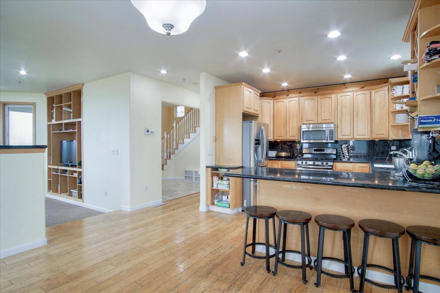 35635 Eagle Ridge Soledad, CA 93960 - Photo 44 of 50 a kitchen with stainless steel appliances granite countertop a table chairs refrigerator and microwave