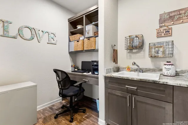 a bathroom with a granite countertop sink mirror and toilet