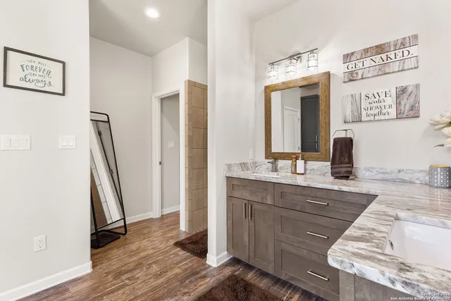 a bath tub sitting next to a white sink