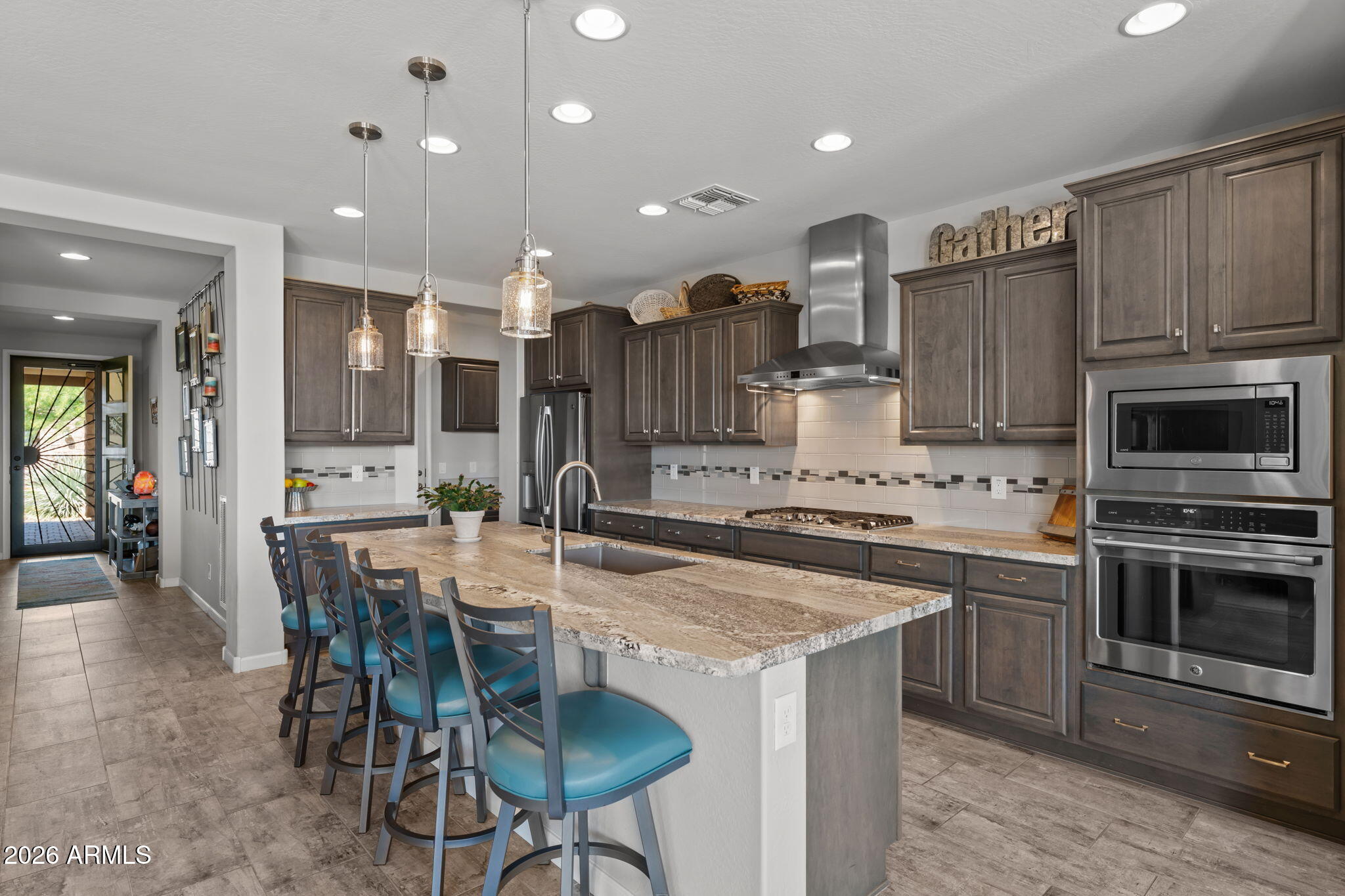 3855 Gold Ridge Road Wickenburg, AZ 85390 - Photo 11 of 38 a kitchen with stainless steel appliances granite countertop a stove top oven a sink dishwasher a dining table and chairs