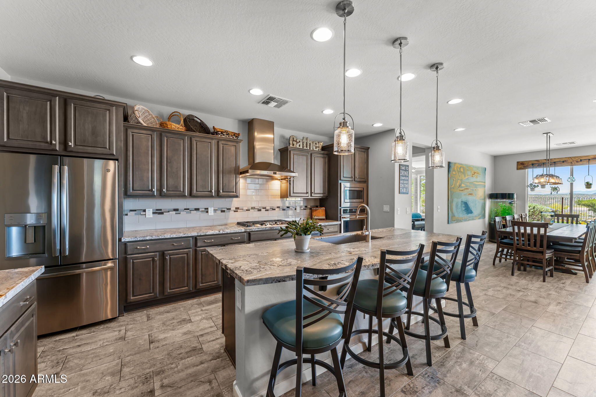 3855 Gold Ridge Road Wickenburg, AZ 85390 - Photo 14 of 38 a large kitchen with a table and chairs