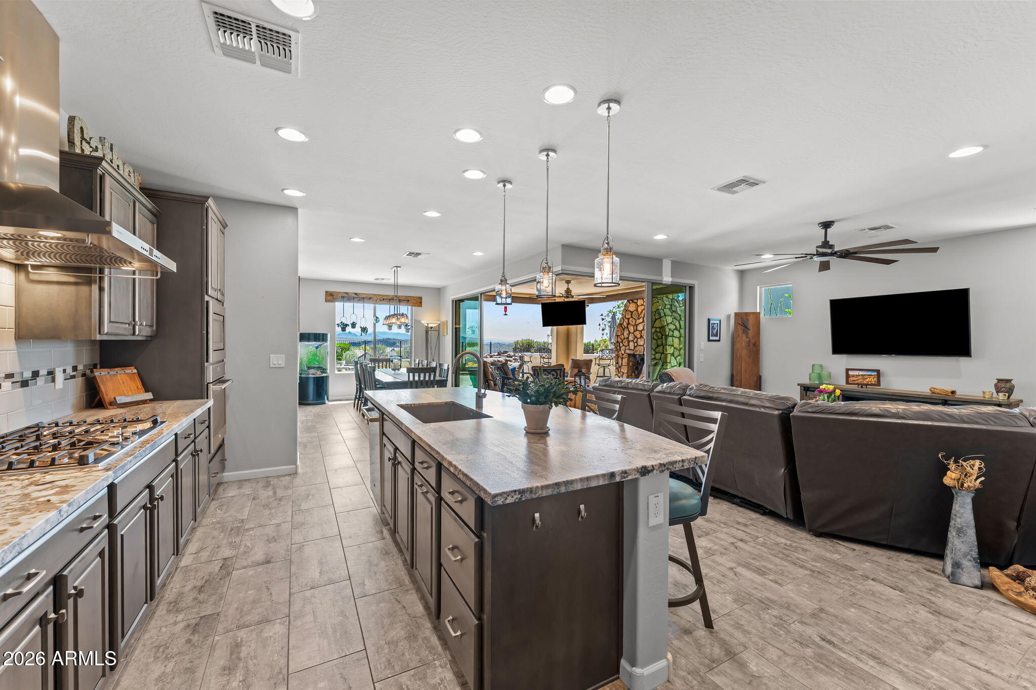 3855 Gold Ridge Road Wickenburg, AZ 85390 - Photo 16 of 38 a kitchen with kitchen island a sink stove and refrigerator
