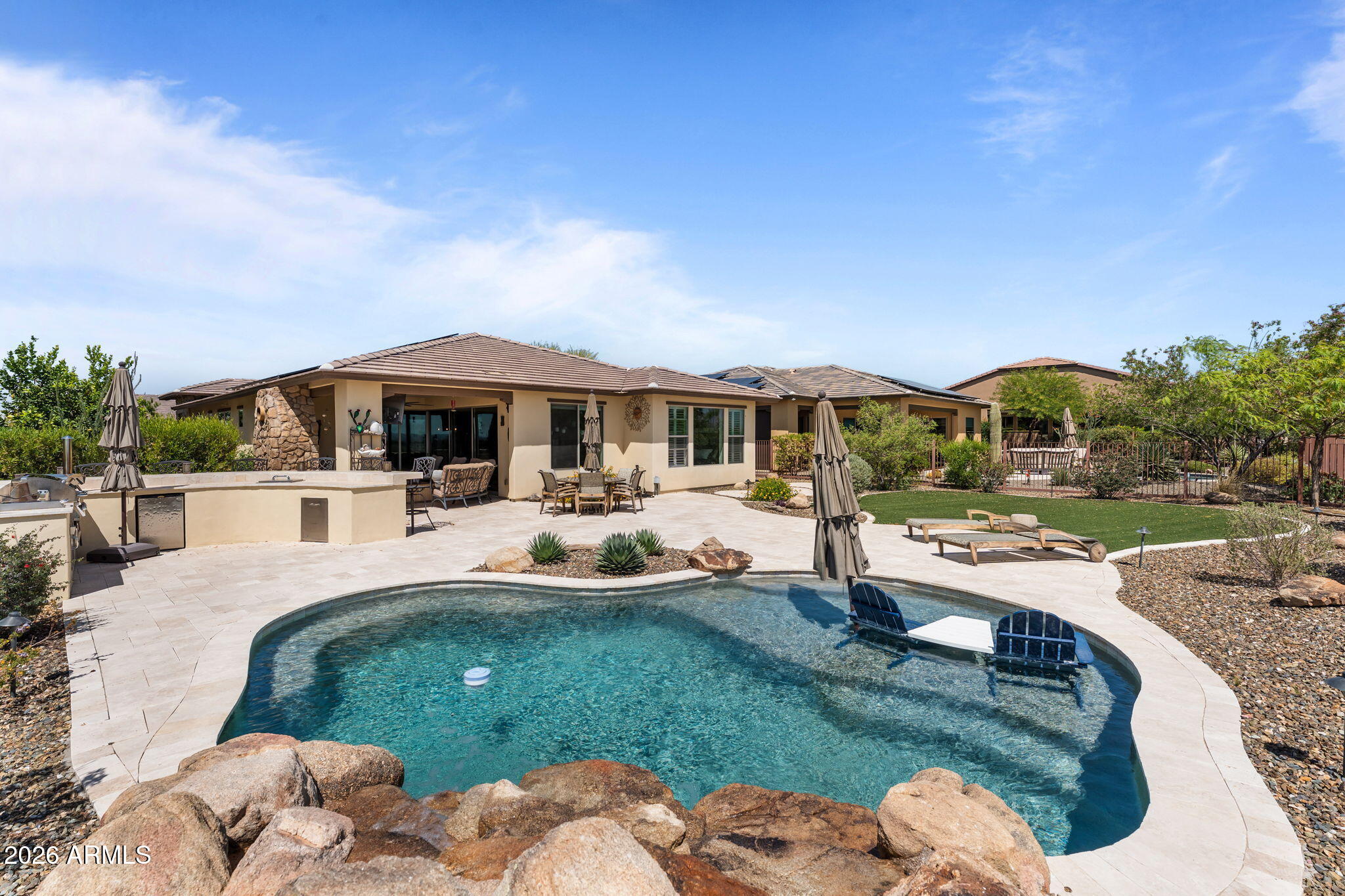 3855 Gold Ridge Road Wickenburg, AZ 85390 - Photo 32 of 38 a swimming pool view with a seating space and a garden view