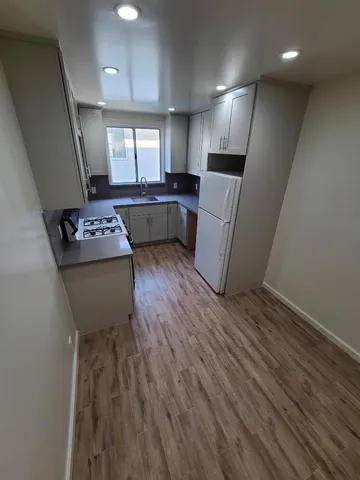 a kitchen with refrigerator and microwave