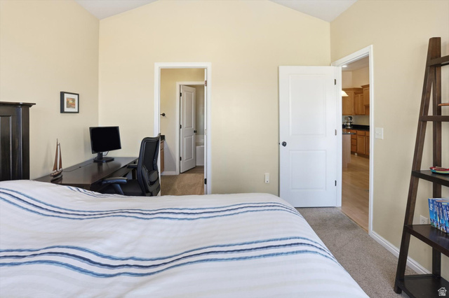 14820 175 East Draper, UT 84020 - Photo 12 of 39 Bedroom with light carpet, vaulted ceiling, and an office area