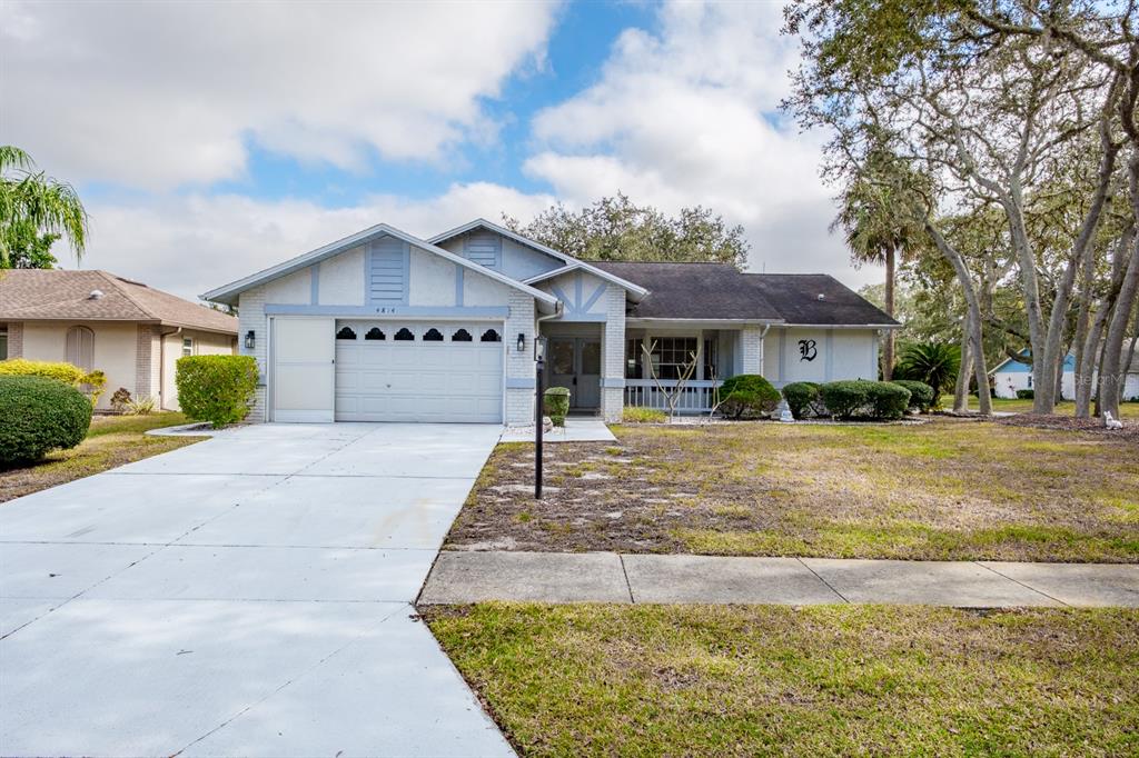 a front view of a house with a yard and a garage