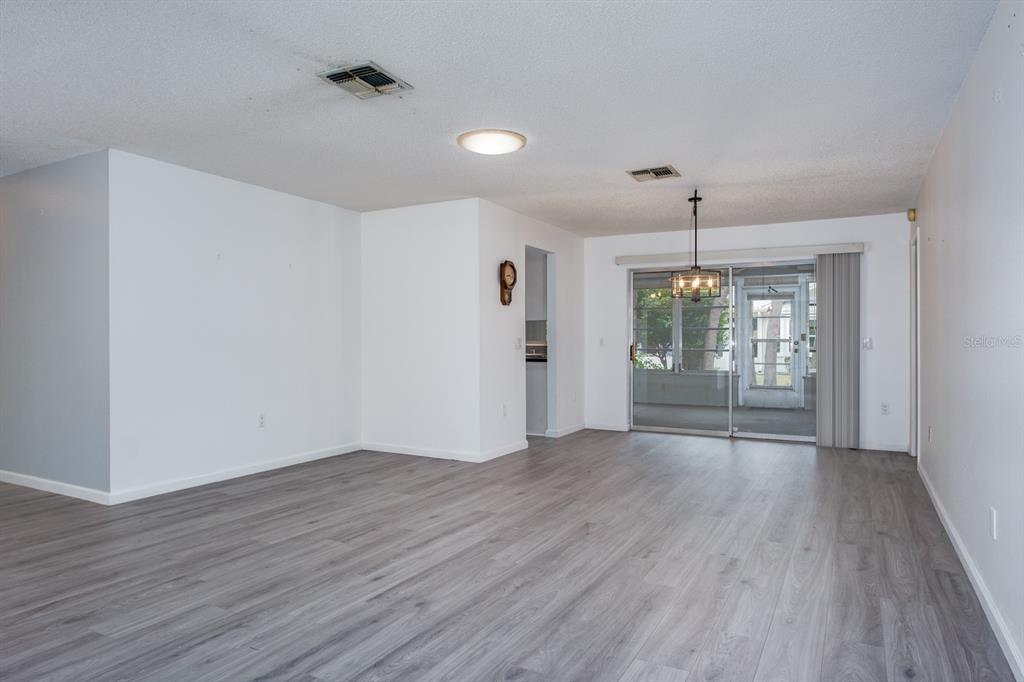 4814 Prince George Circle New Port Richey, FL 34655 - Photo 11 of 75 wooden floor in an empty room with a window