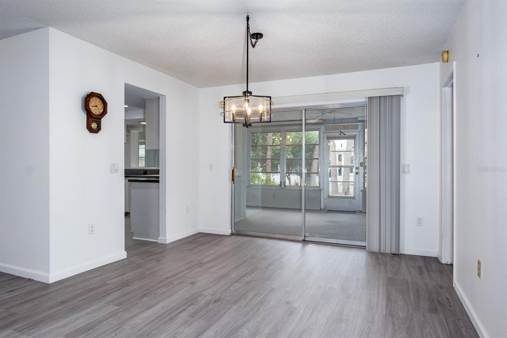 4814 Prince George Circle New Port Richey, FL 34655 - Photo 12 of 75 a view of a kitchen with a refrigerator wooden floor and a window