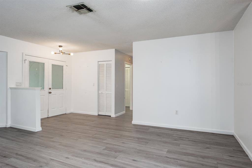 4814 Prince George Circle New Port Richey, FL 34655 - Photo 16 of 75 a view of an empty room with wooden floor
