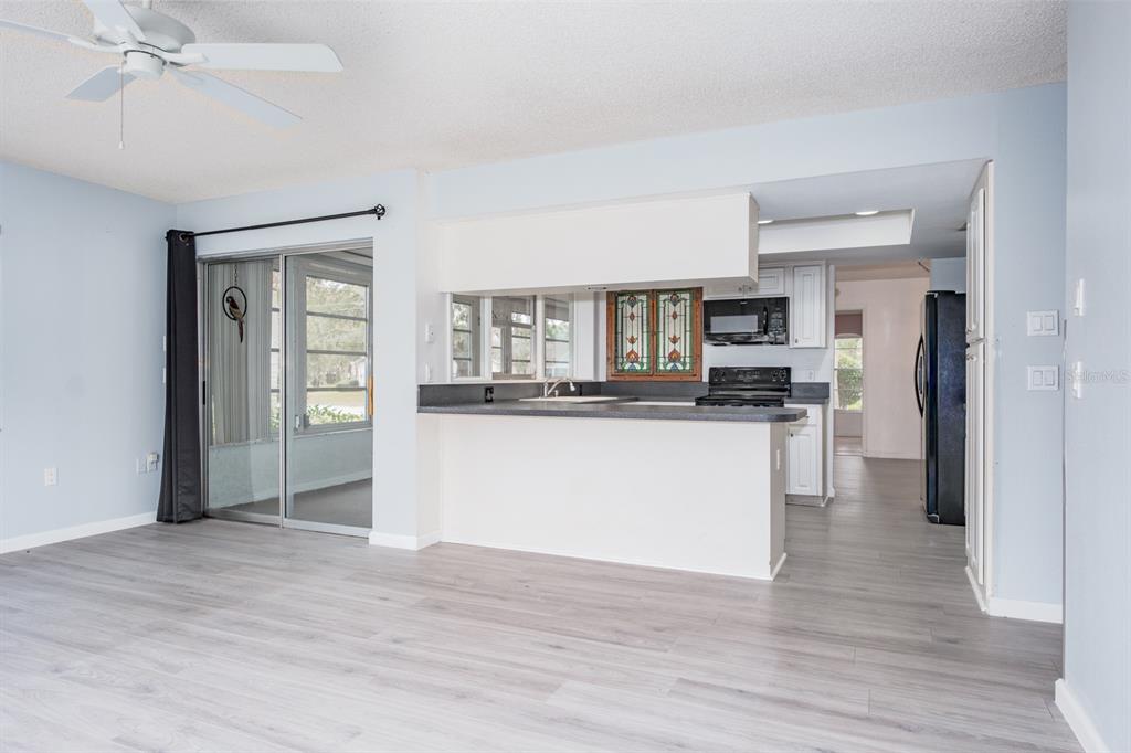 4814 Prince George Circle New Port Richey, FL 34655 - Photo 22 of 75 a kitchen with stainless steel appliances kitchen island wooden cabinets and refrigerator
