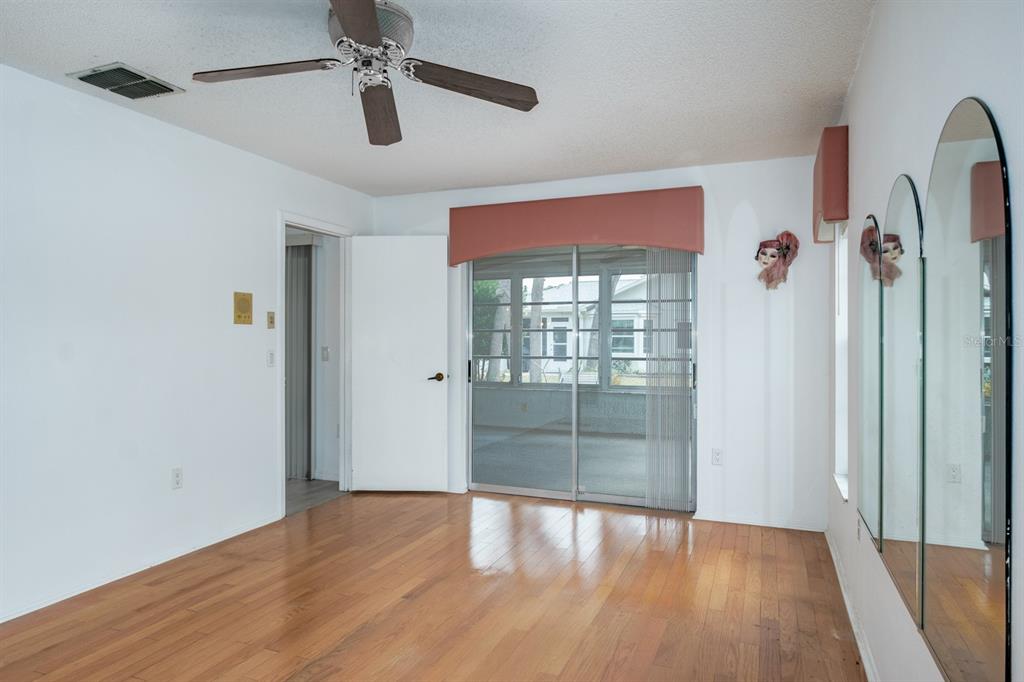 4814 Prince George Circle New Port Richey, FL 34655 - Photo 30 of 75 wooden floor in an empty room with a window