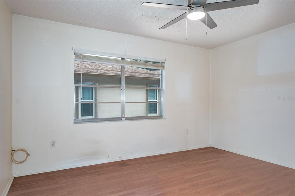 4814 Prince George Circle New Port Richey, FL 34655 - Photo 35 of 75 an empty room with a window and ceiling fan