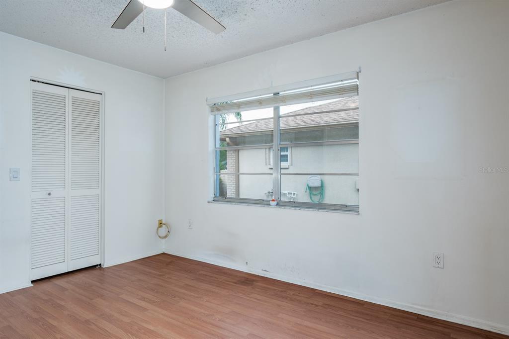 4814 Prince George Circle New Port Richey, FL 34655 - Photo 36 of 75 an empty room with wooden floor and a window