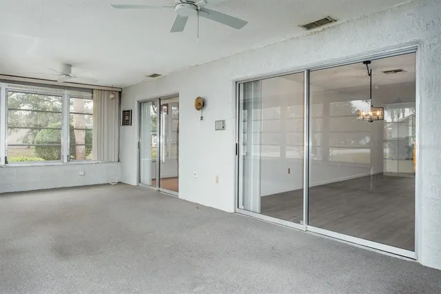 a view of a house with backyard porch and sitting area
