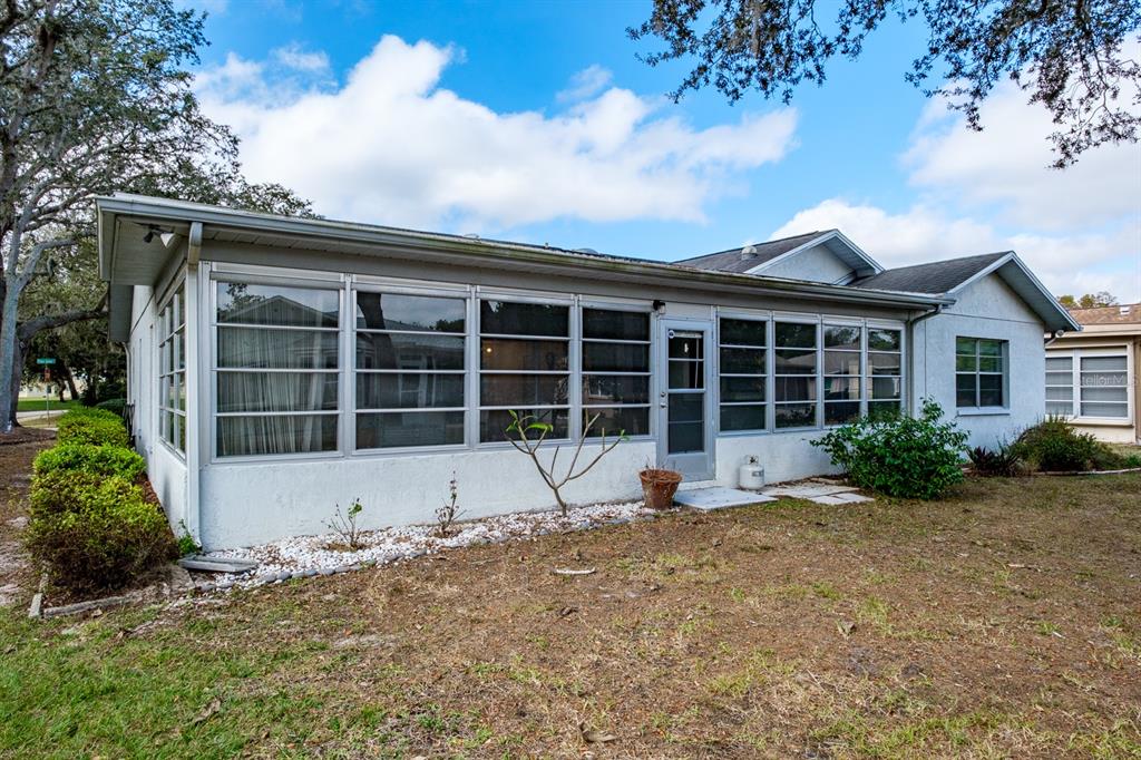 4814 Prince George Circle New Port Richey, FL 34655 - Photo 47 of 75 a view of a house with a yard and sitting area