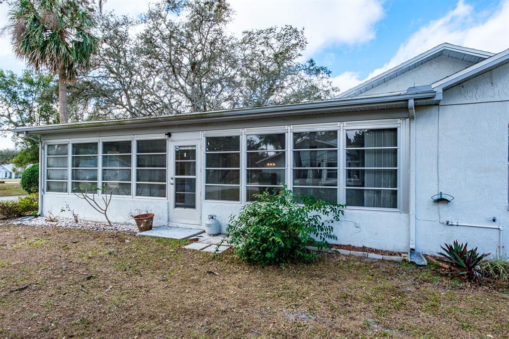 4814 Prince George Circle New Port Richey, FL 34655 - Photo 48 of 75 a front view of a house with garden and porch
