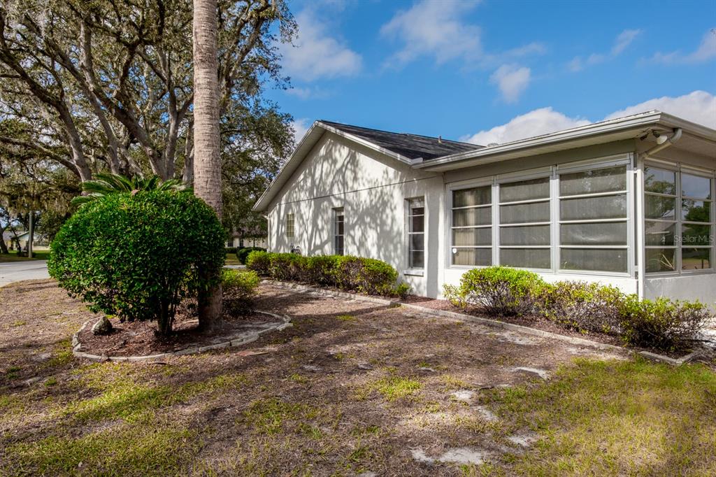 4814 Prince George Circle New Port Richey, FL 34655 - Photo 53 of 75 a view of a house with a yard and potted plants