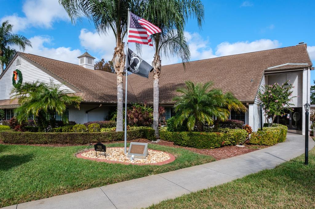 4814 Prince George Circle New Port Richey, FL 34655 - Photo 57 of 75 front view of house with a yard and potted plants