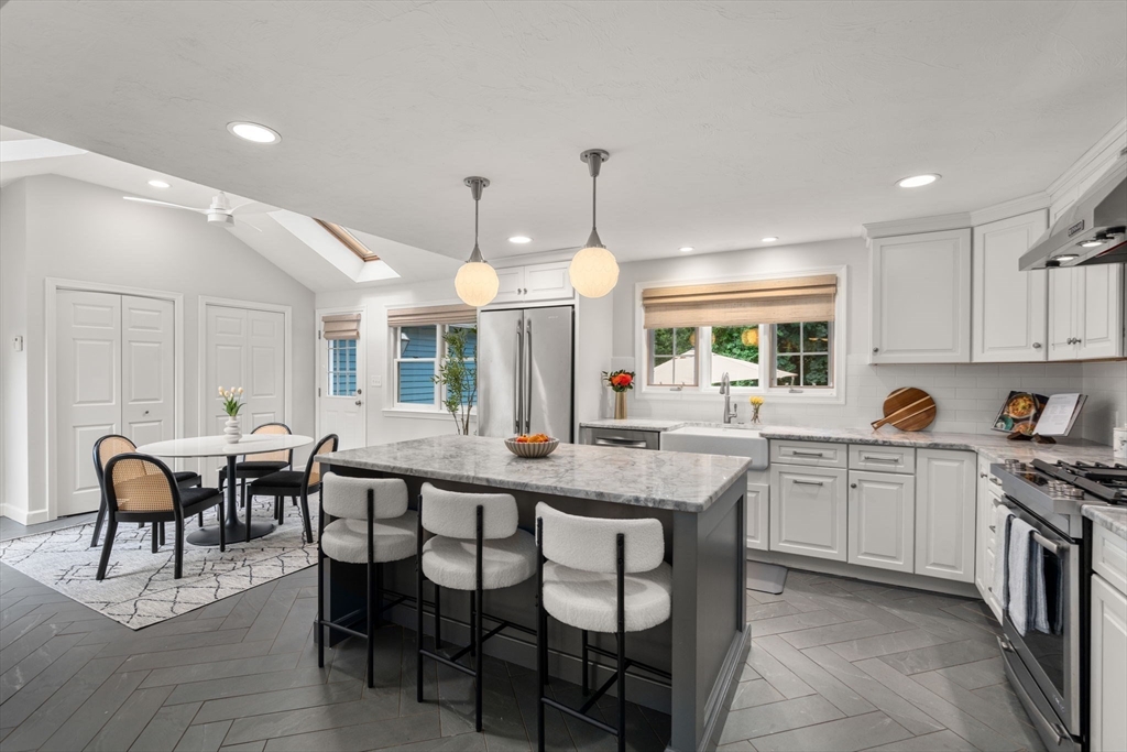 429 Warren Street Needham, MA 02492 - Photo 11 of 40 a large kitchen with lots of furniture and stainless steel appliances