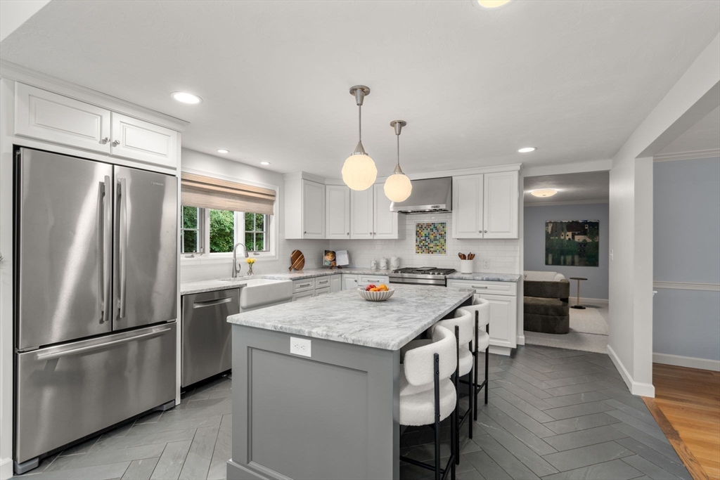 429 Warren Street Needham, MA 02492 - Photo 13 of 40 a kitchen with a refrigerator a sink and wooden floor