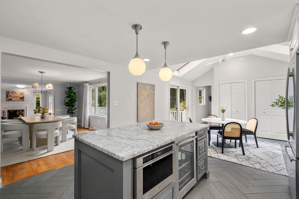 429 Warren Street Needham, MA 02492 - Photo 14 of 40 a open kitchen with granite countertop a stove and a table