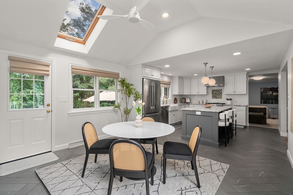 429 Warren Street Needham, MA 02492 - Photo 16 of 40 a view of a dining room with furniture a rug and wooden floor