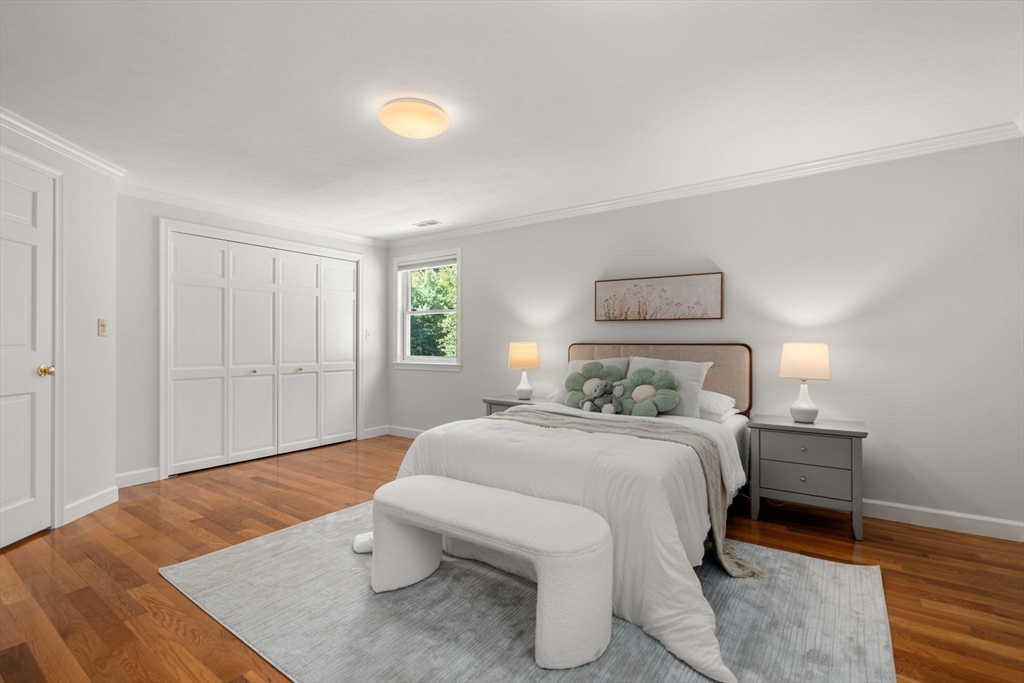 429 Warren Street Needham, MA 02492 - Photo 22 of 40 a bedroom with a bed and a lamp