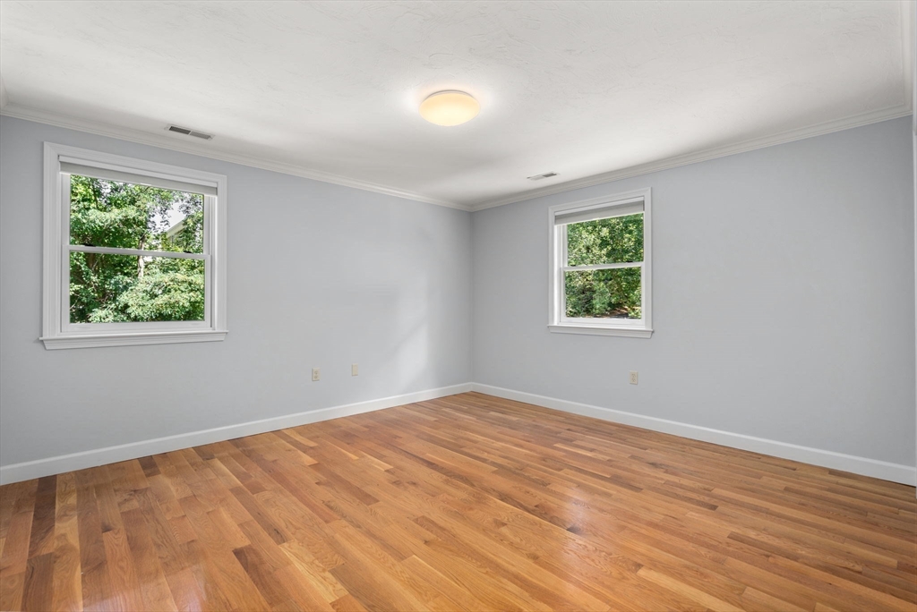 429 Warren Street Needham, MA 02492 - Photo 25 of 40 a view of an empty room with wooden floor and a window