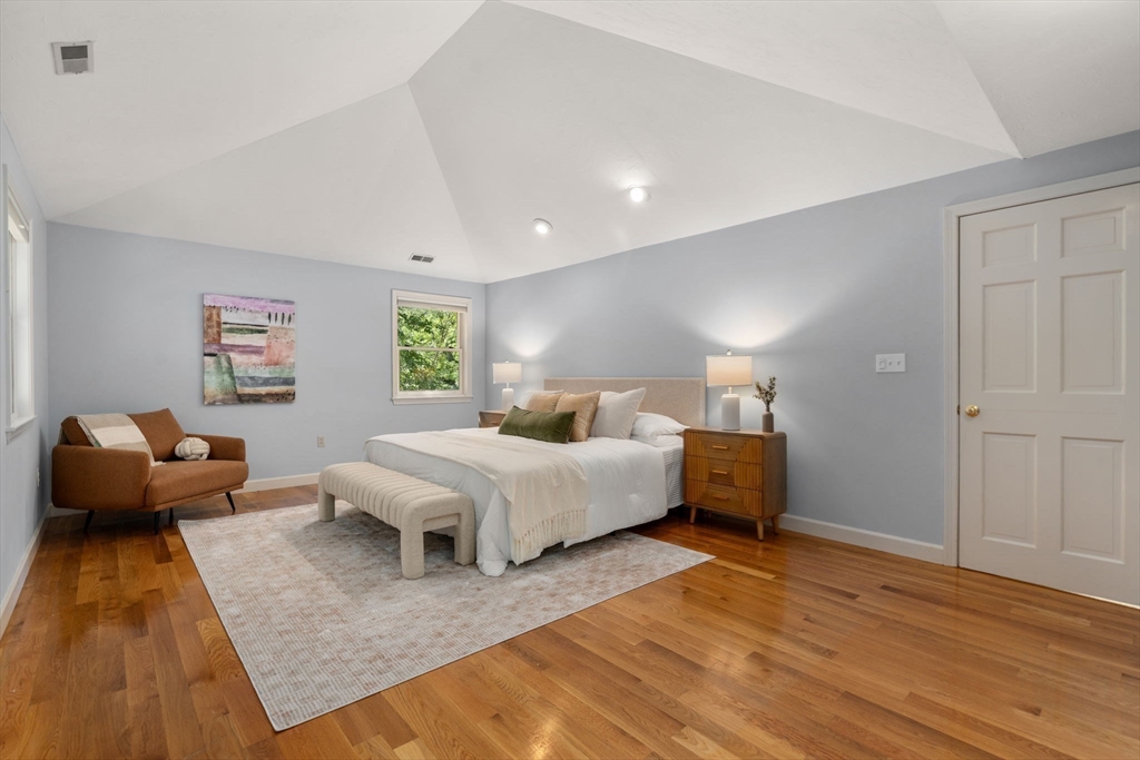 429 Warren Street Needham, MA 02492 - Photo 27 of 40 a spacious bedroom with a bed and wooden floor