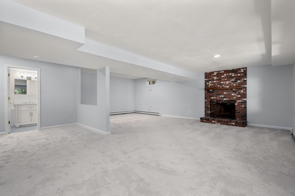 429 Warren Street Needham, MA 02492 - Photo 31 of 40 an empty room with a fireplace and window