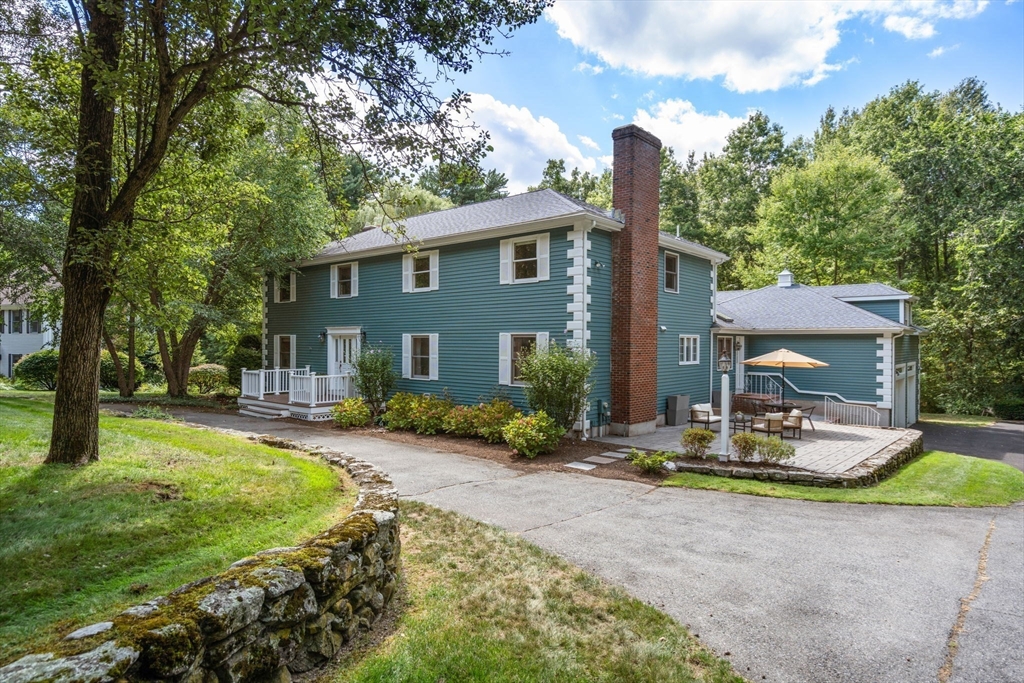 429 Warren Street Needham, MA 02492 - Photo 33 of 40 a front view of a house with garden and patio