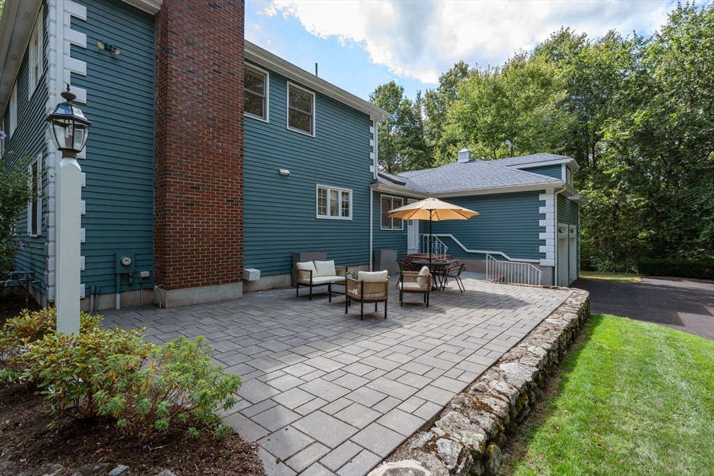 429 Warren Street Needham, MA 02492 - Photo 34 of 40 a view of backyard with table and chairs and potted plants