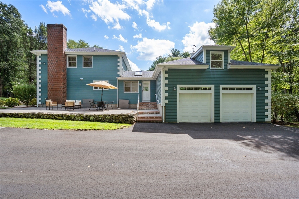 429 Warren Street Needham, MA 02492 - Photo 35 of 40 a front view of a house with a yard and garage