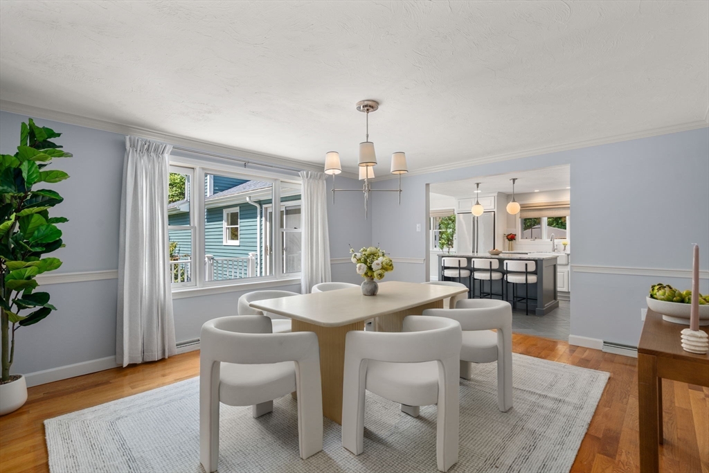429 Warren Street Needham, MA 02492 - Photo 10 of 40 a view of a dining room with furniture and wooden floor
