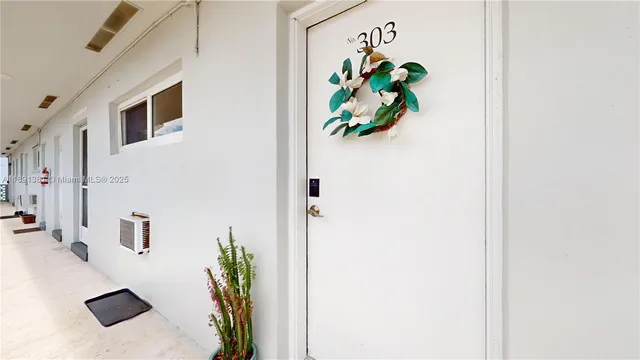 a white vase with flowers