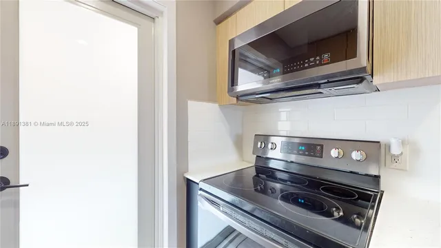 a kitchen with a stove and a microwave