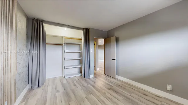 a view of an empty room with a closet