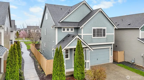 a view of a house with wooden fence