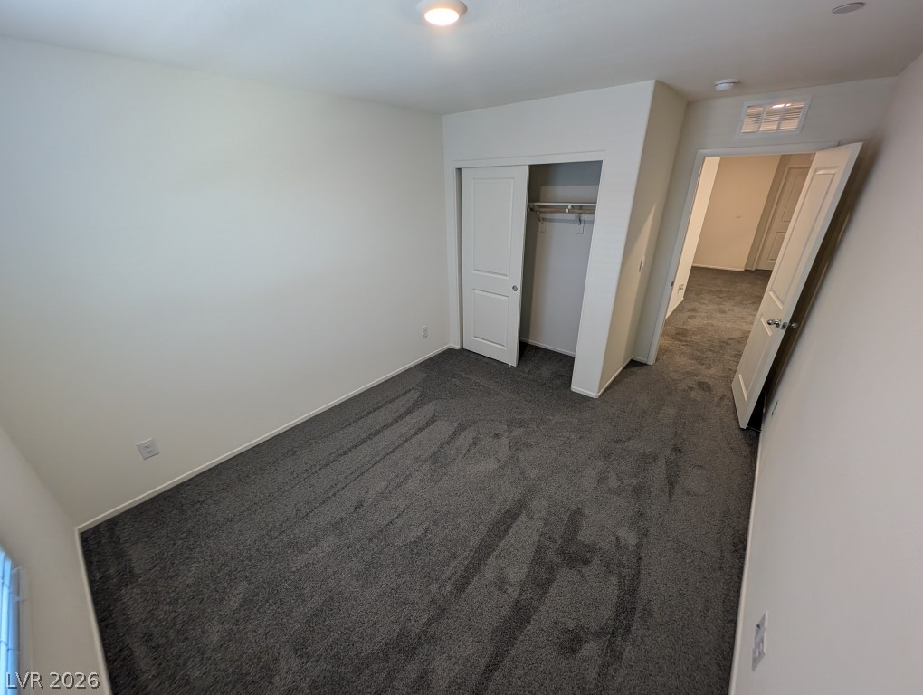 4820 Orchid Rdg Avenue Las Vegas, NV 89141 - Photo 26 of 27 A well-lit bedroom features plush carpeting and a convenient sliding closet door.