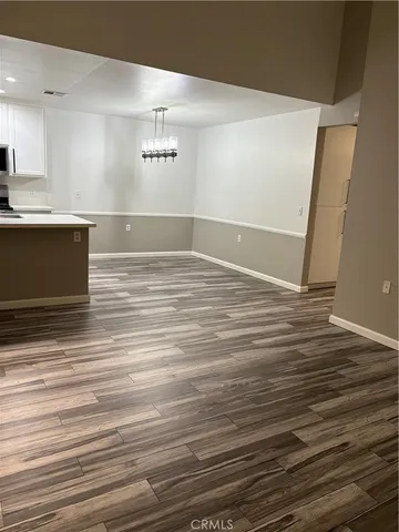 a view of a room with wooden floor