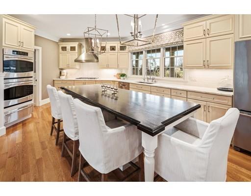 3 Gardner Terrace Hingham, MA 02043 - Photo 16 of 29 a kitchen with stainless steel appliances granite countertop a table chairs and stove