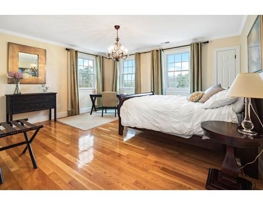 3 Gardner Terrace Hingham, MA 02043 - Photo 23 of 29 a bedroom with a bed and a chandelier
