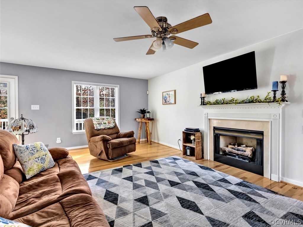 11307 Corte Castle Road Chesterfield, VA 23838 - Photo 6 of 41 a living room with furniture a flat screen tv and a fireplace