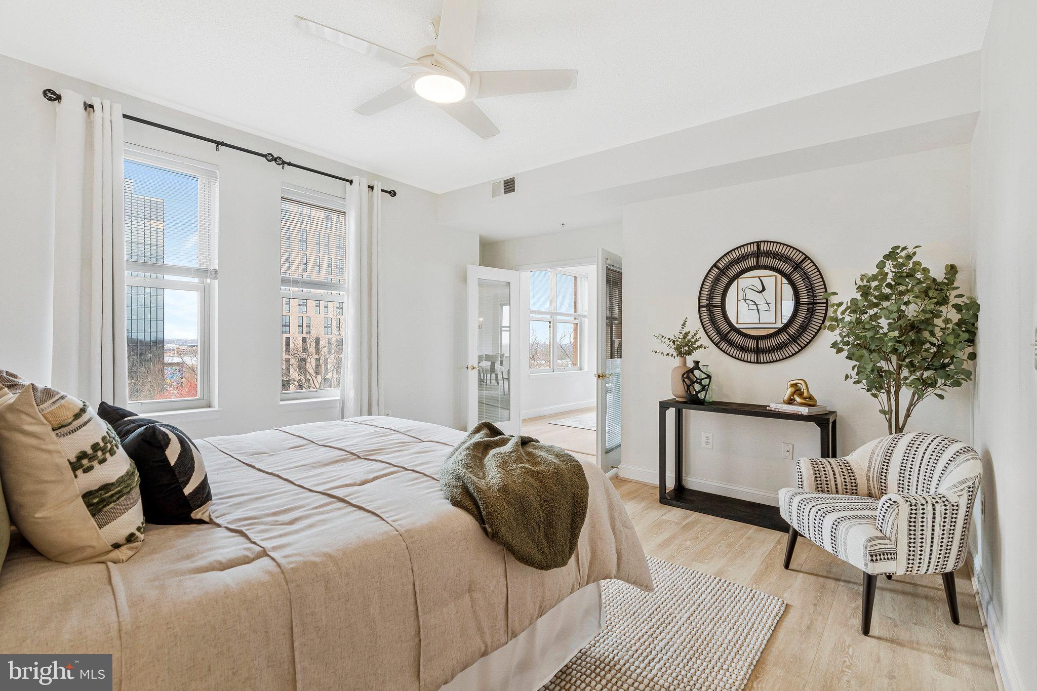 11776 Stratford House Place, Unit 807 Reston, VA 20190 - Photo 12 of 25 a bedroom with a bed and a chandelier