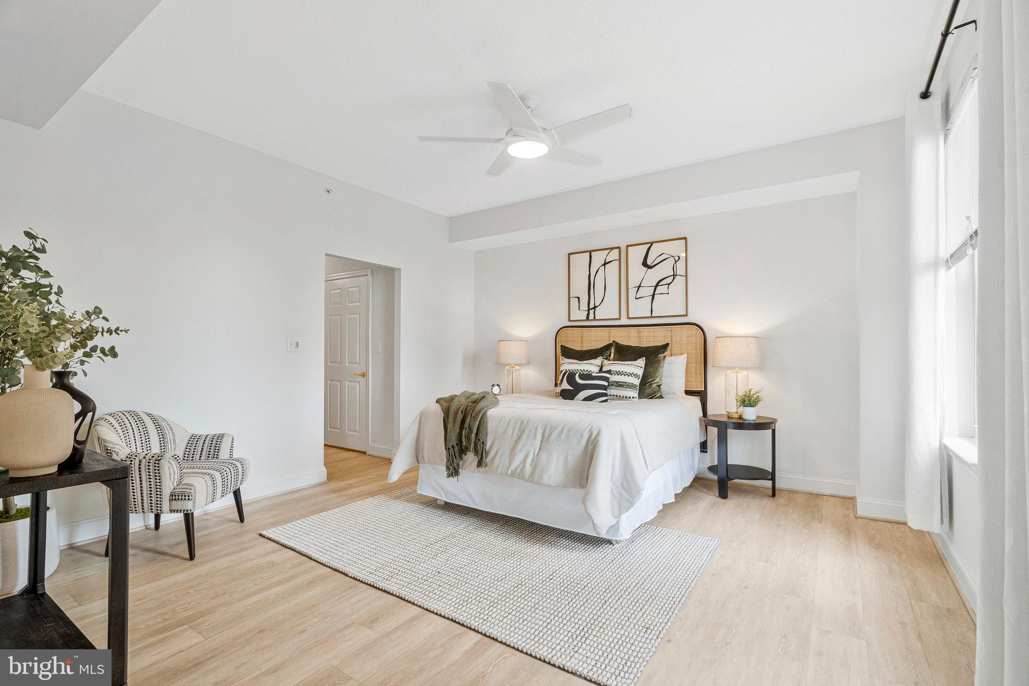 11776 Stratford House Place, Unit 807 Reston, VA 20190 - Photo 13 of 25 a bedroom with a bed and a table