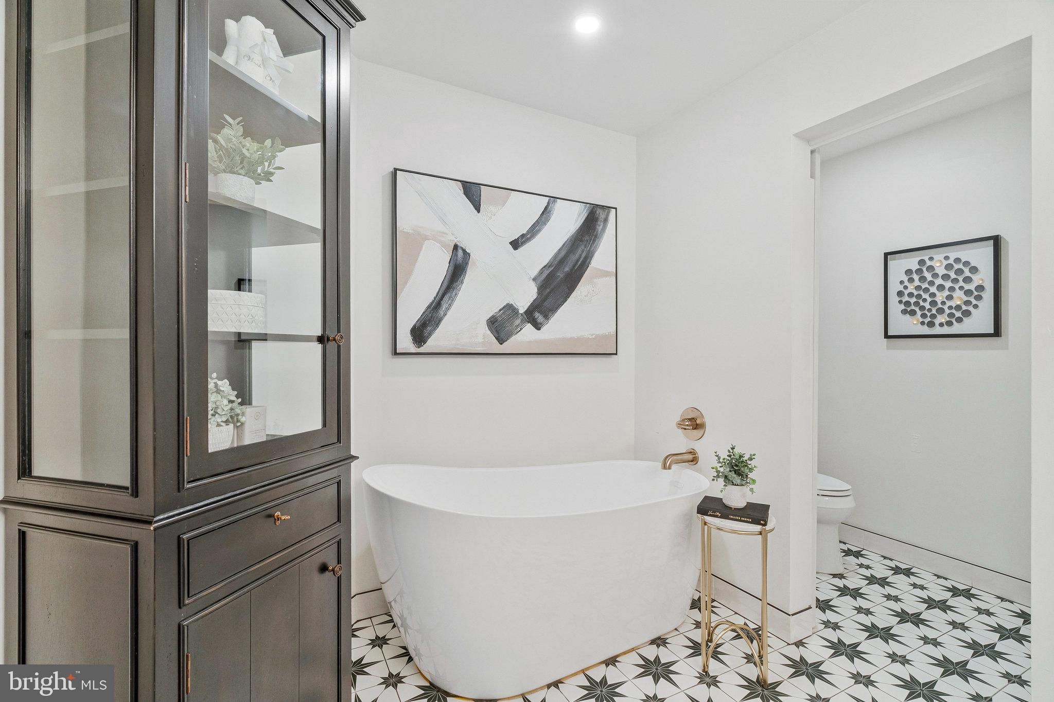 11776 Stratford House Place, Unit 807 Reston, VA 20190 - Photo 16 of 25 a white bath tub sitting next to a white toilet