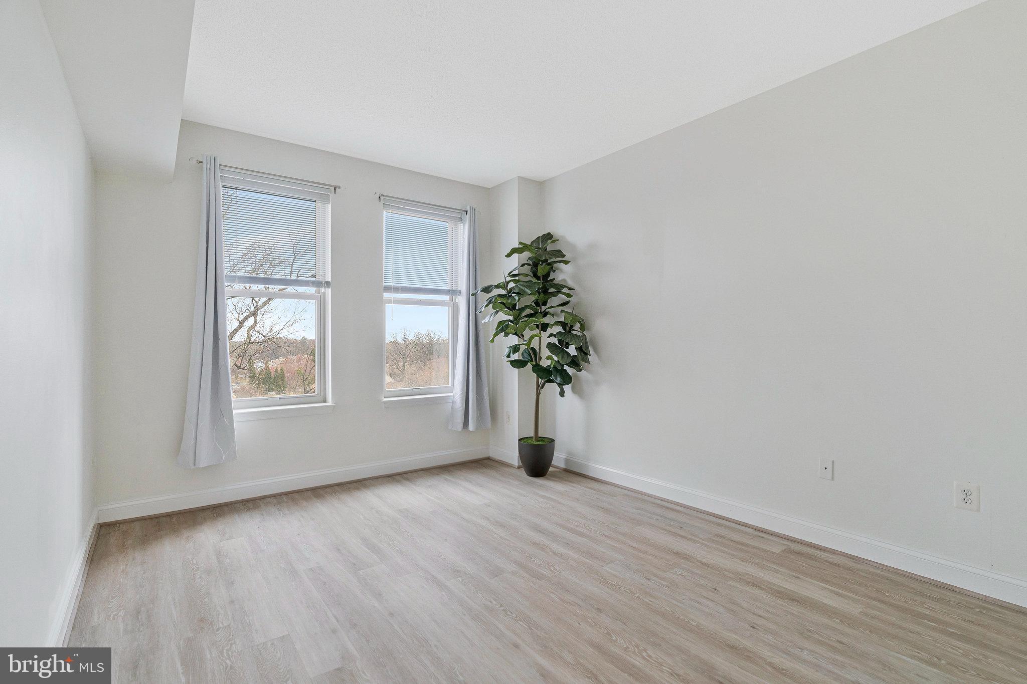 11776 Stratford House Place, Unit 807 Reston, VA 20190 - Photo 18 of 25 a view of empty room with window and wooden floor