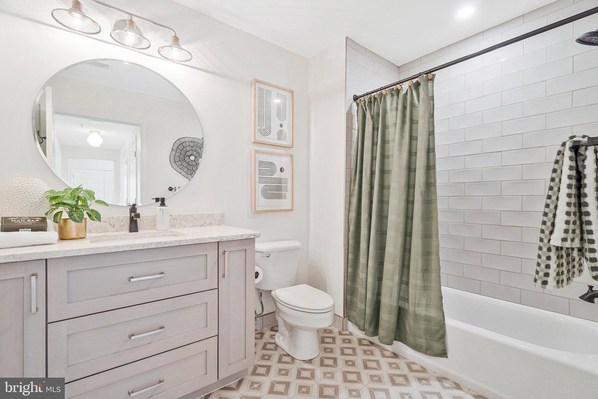 11776 Stratford House Place, Unit 807 Reston, VA 20190 - Photo 19 of 25 a bathroom with a sink a toilet and shower